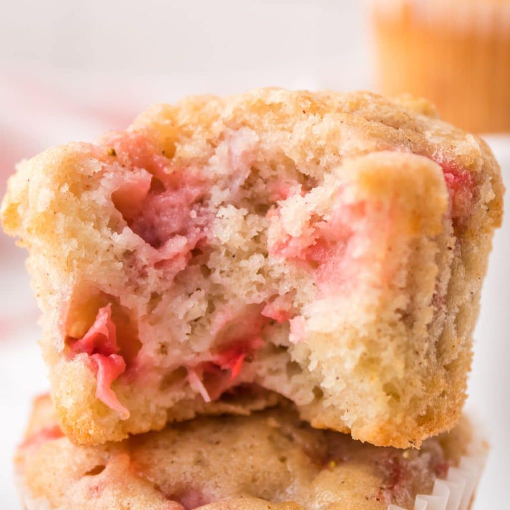 Strawberry muffin with bite taken out. 