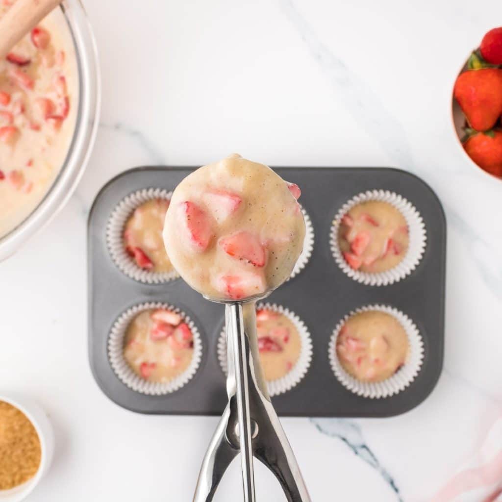 Cookie scoop with muffin mix.