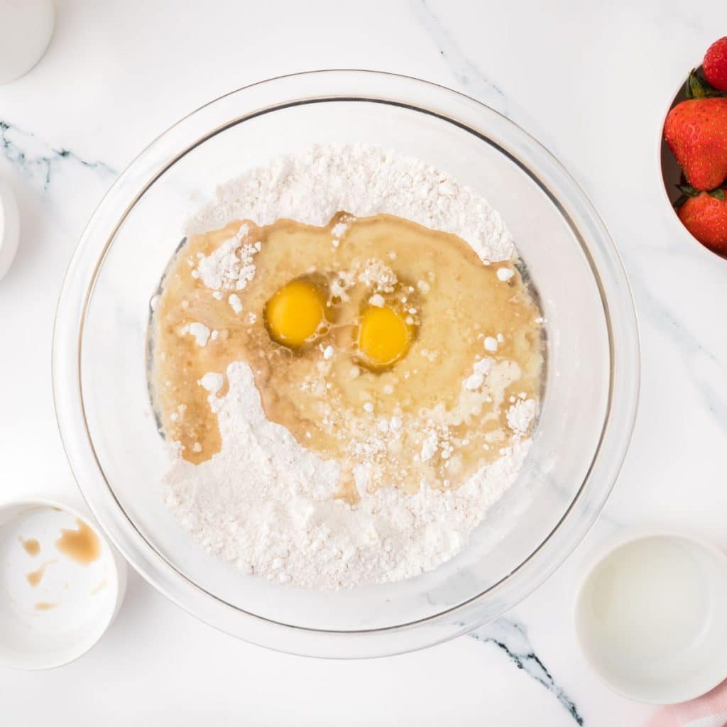 Bowl of flour with eggs.