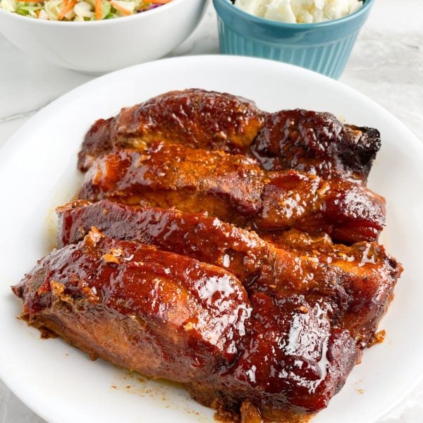 Cooked BBQ ribs on a plate.