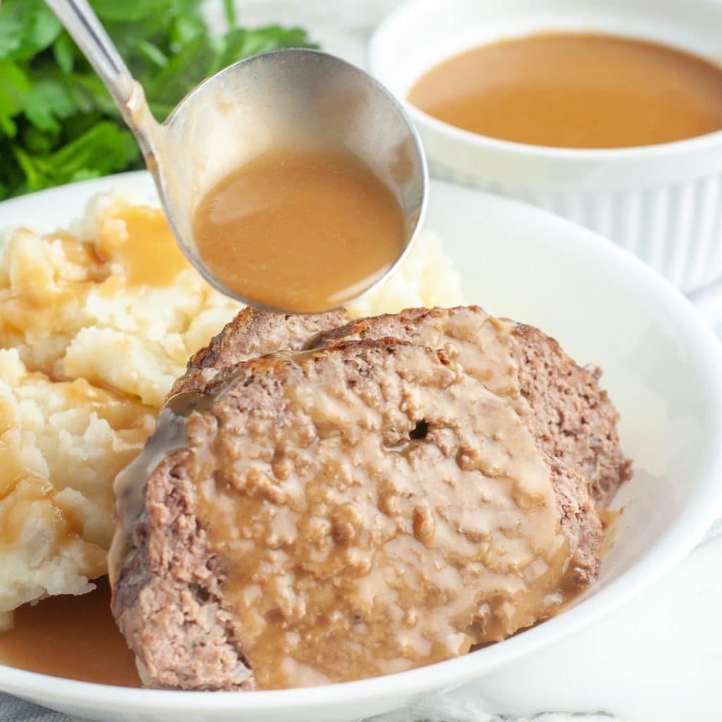 Slices of meatloaf and mashed potatoes.