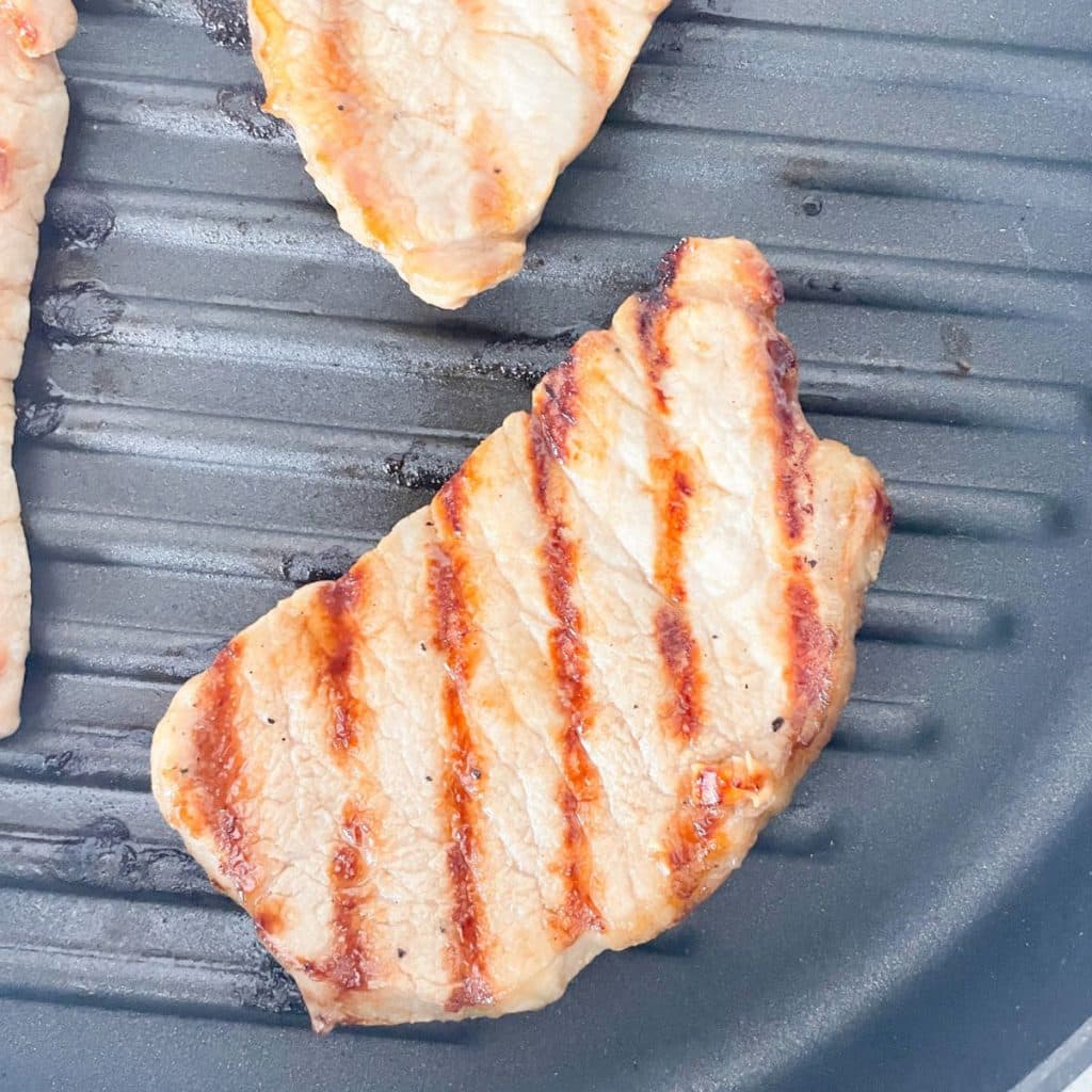 Grilled pork chop on a pan.