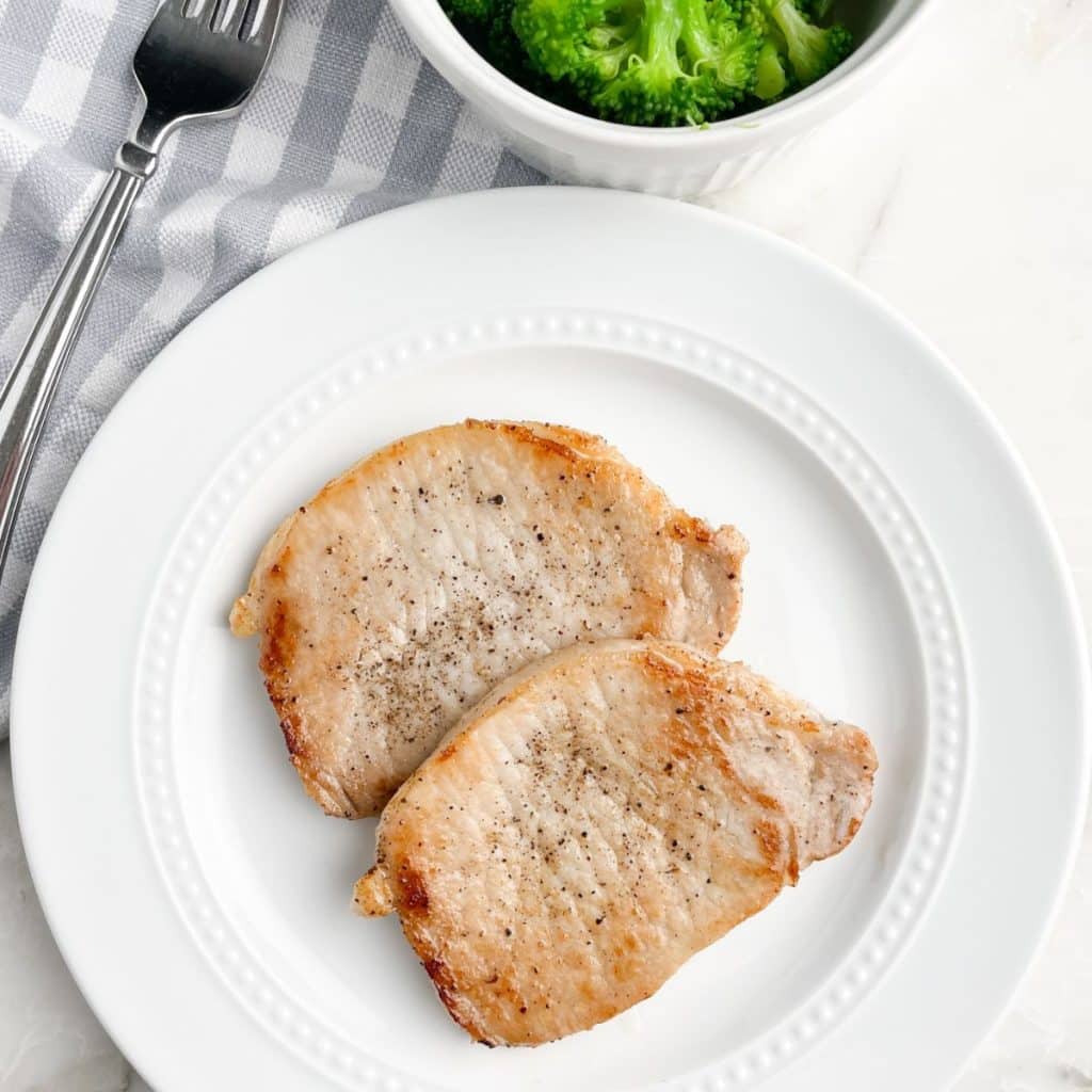 Plate with cooked pork chops. 