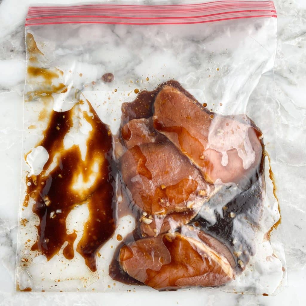 Plastic bag with marinade and pork chops. 