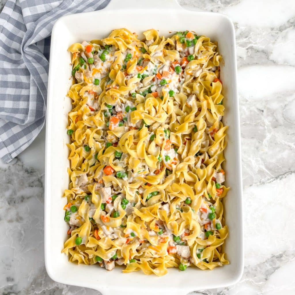 Casserole dish with egg noodles and veggies. 