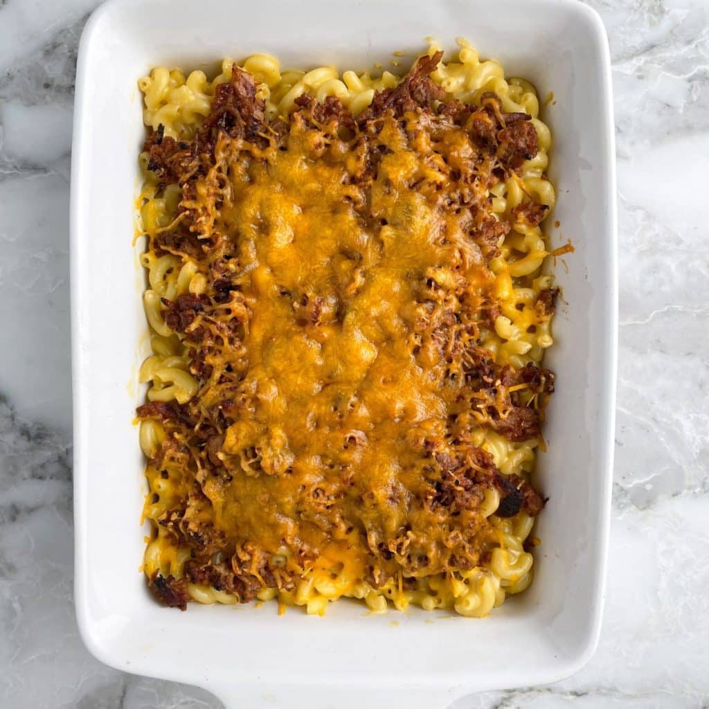 Casserole dish with mac and cheese and bbq. 