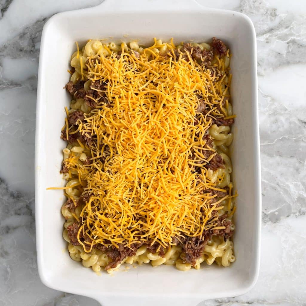 Casserole dish with macaroni and cheese and bbq. 