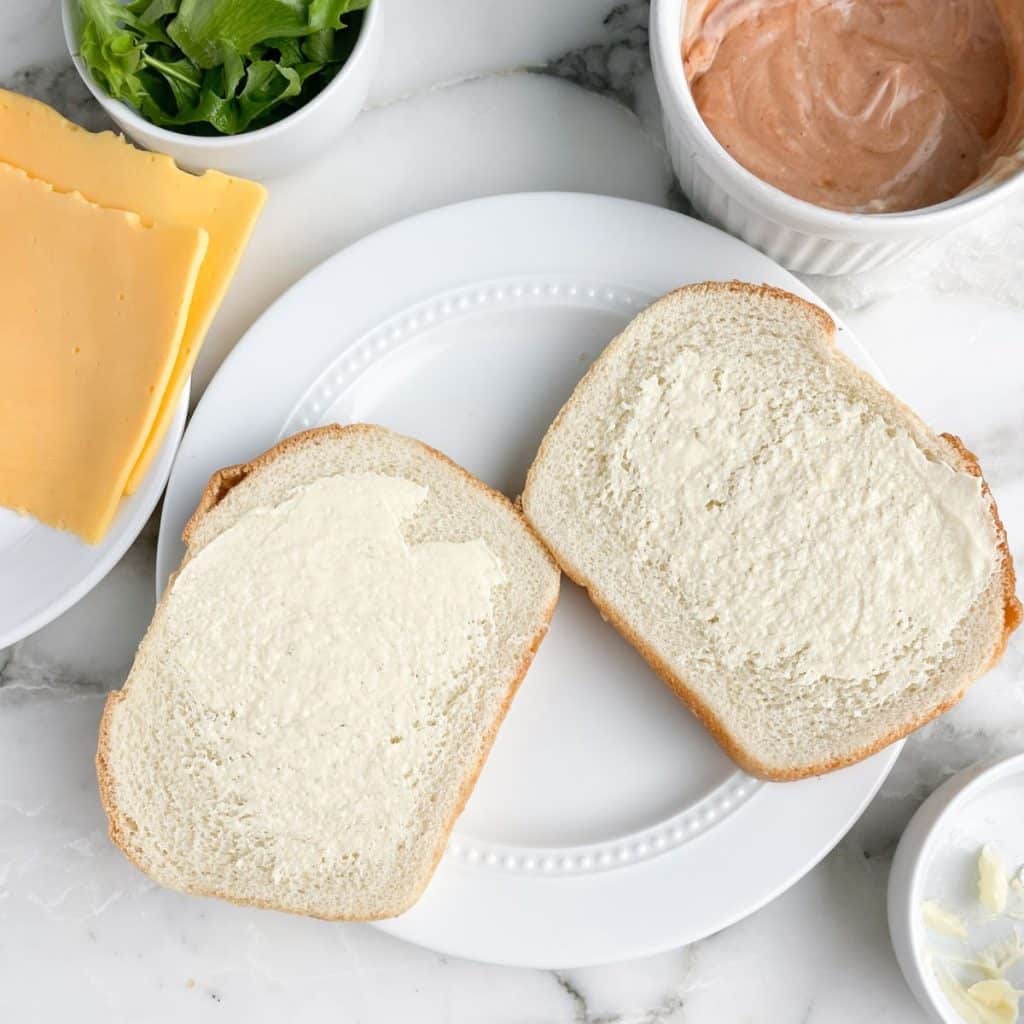 Bread with butter spread on the slices.