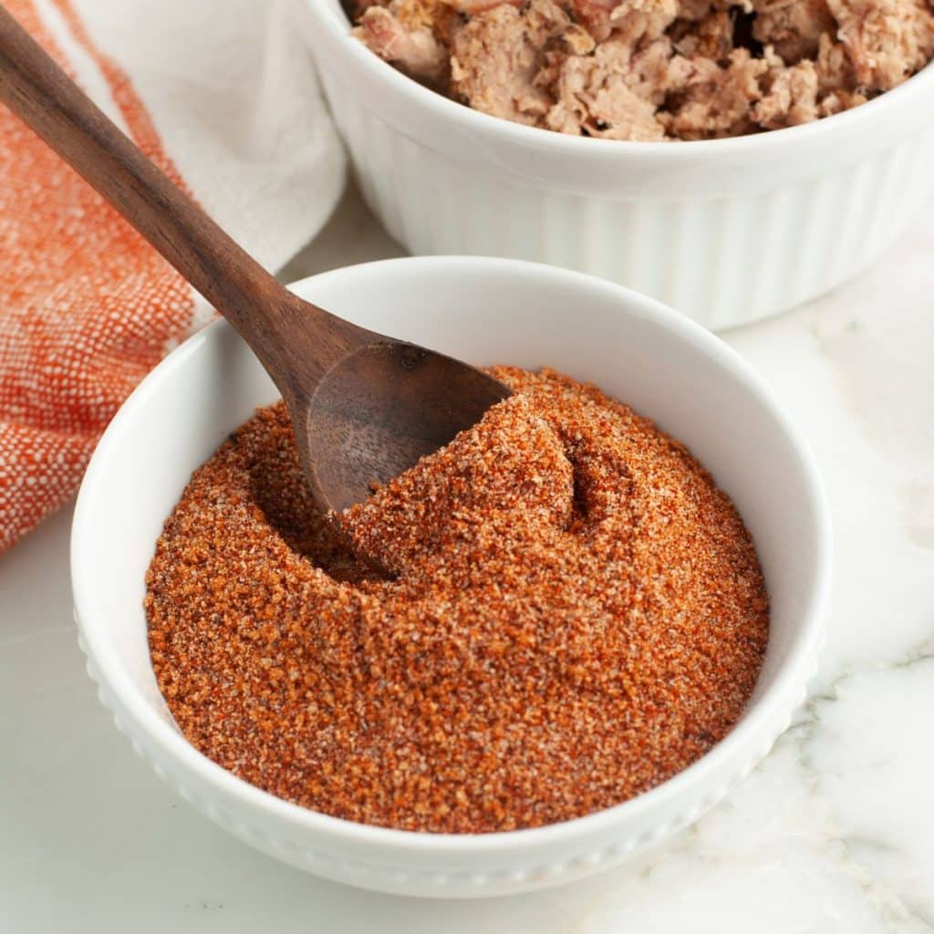 Bowl of seasoning mix with a wooden spoon. 