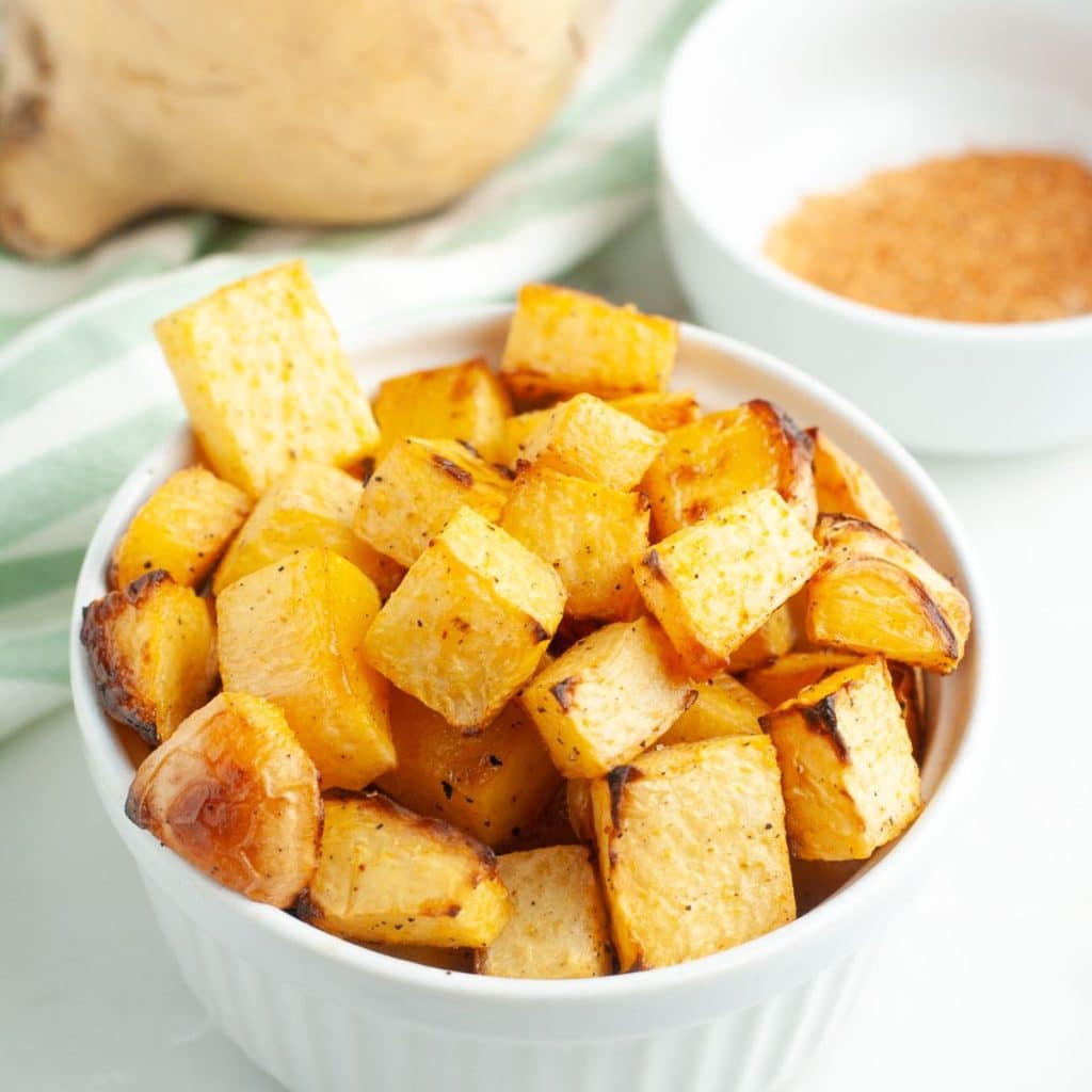 Bowl full of diced, roasted rutabaga. 