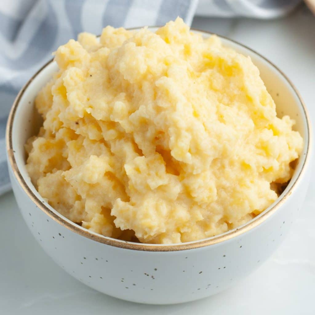 Bowl filled with mashed rutabaga. 