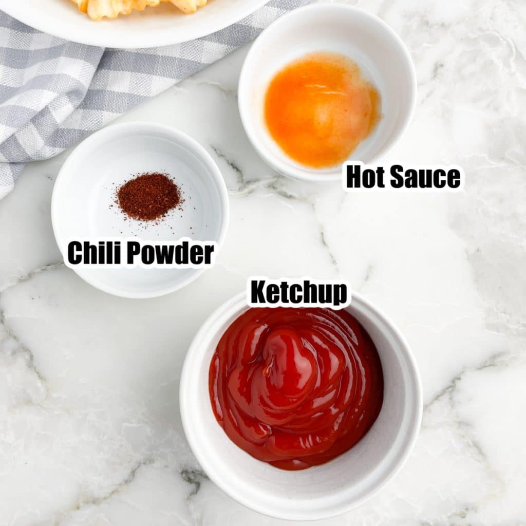 Bowl of hot sauce, chili powder, and ketchup. 