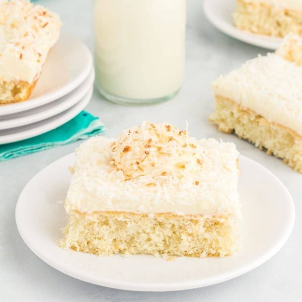 Slice of coconut cake on a plate.