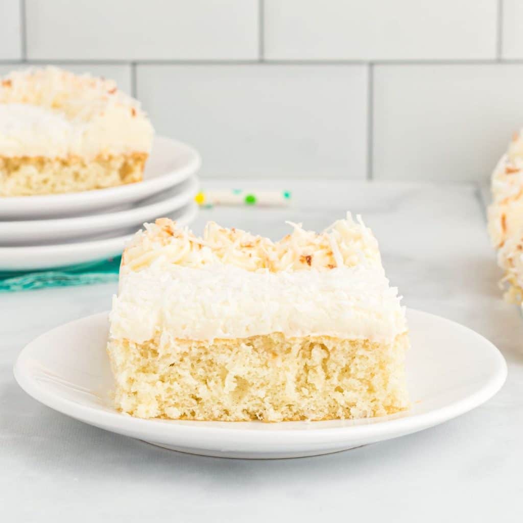 Piece of coconut cake on a plate.