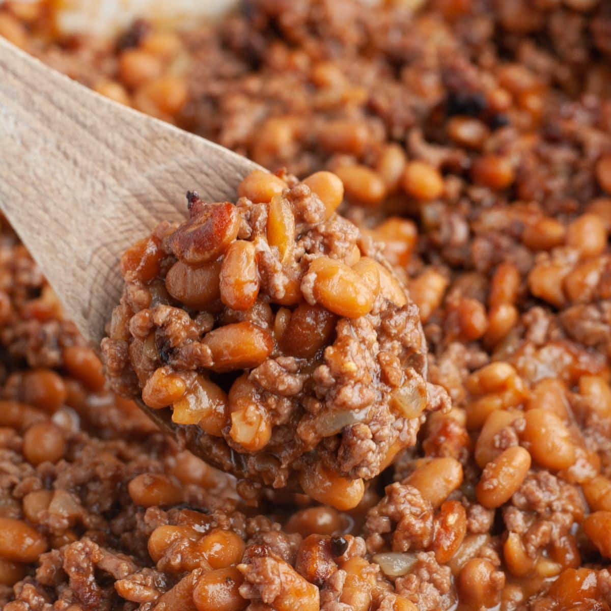 Wooden spoon with baked beans.