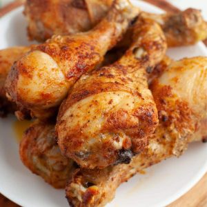 Baked chicken legs on a plate.