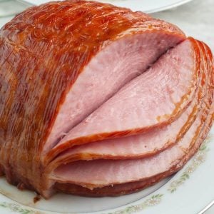 Baked ham on a plate.