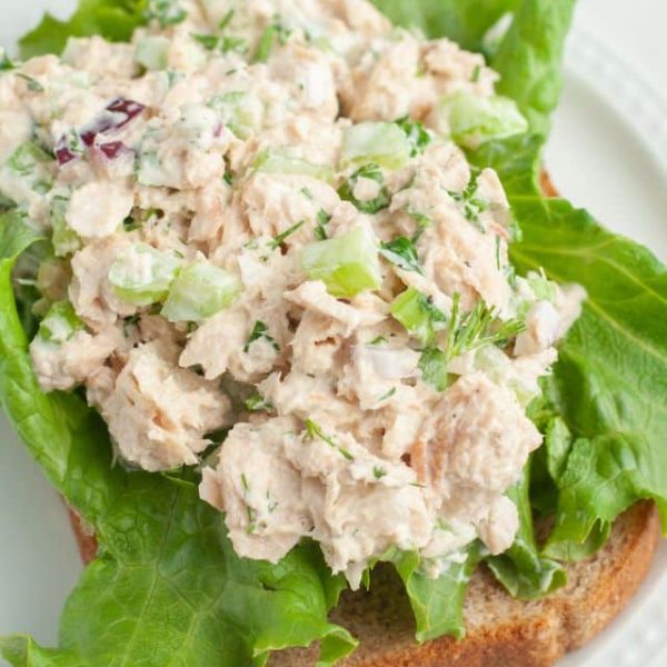 Salmon salad on lettuce and bread.