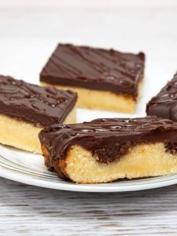 Plate of yellow cake with chocolate frosting.