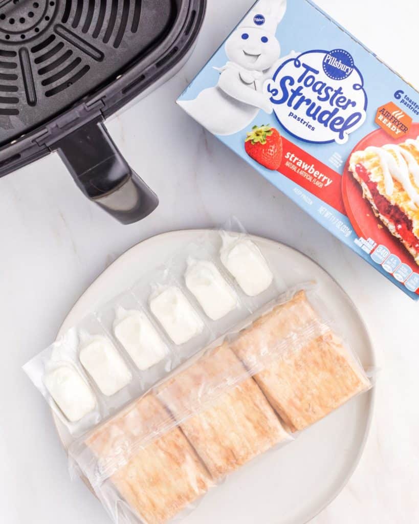 Box of toaster strudel and an air fryer basket. 