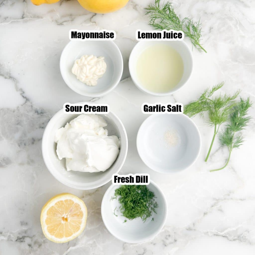 Bowls of sour cream, mayonnaise, lemon juice, dill, and garlic salt. 