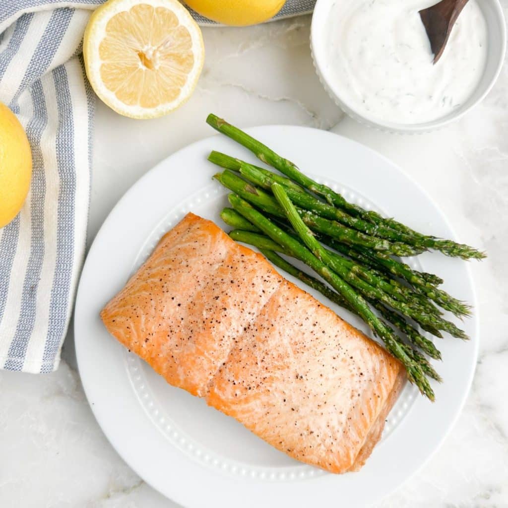 Cooked oven and asparagus on a plate. 