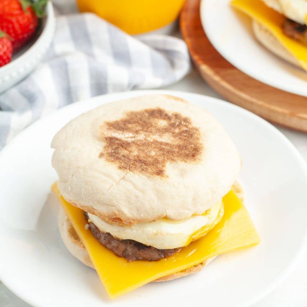 English muffin with sausage and cheese sandwich. 