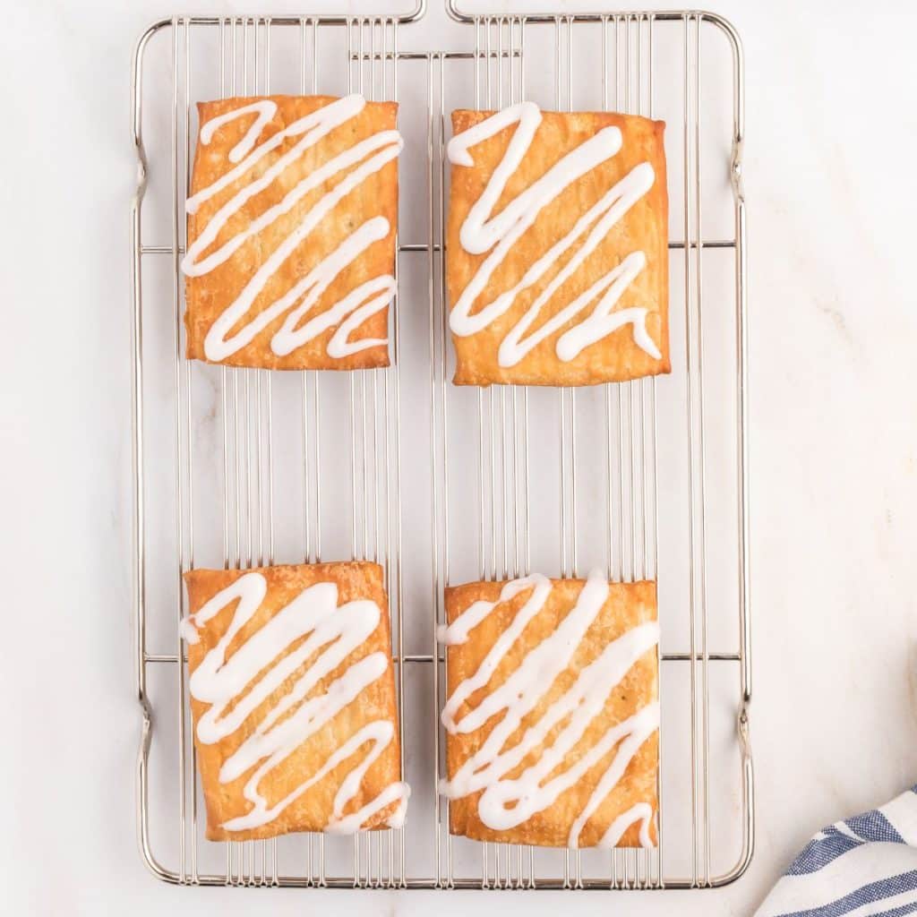 Four toaster strudel on a wire rack. 