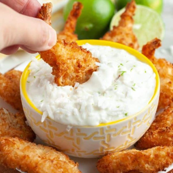 Bowl of creamy dip and fried shrimp.