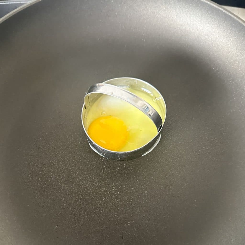 Egg in a biscuit cutter in a skillet.