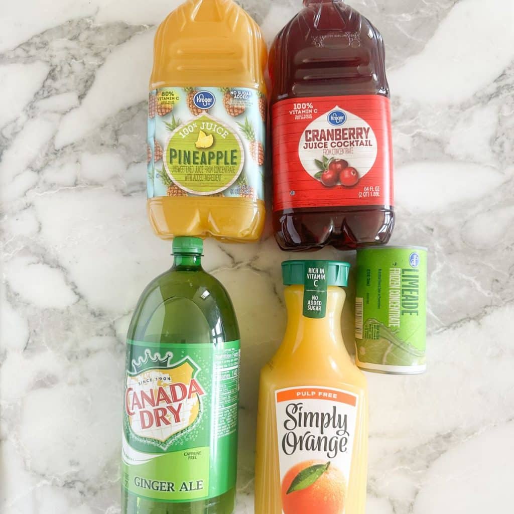 Bottles of pineapple juice, cranberry juice, orange juice, and ginger ale.