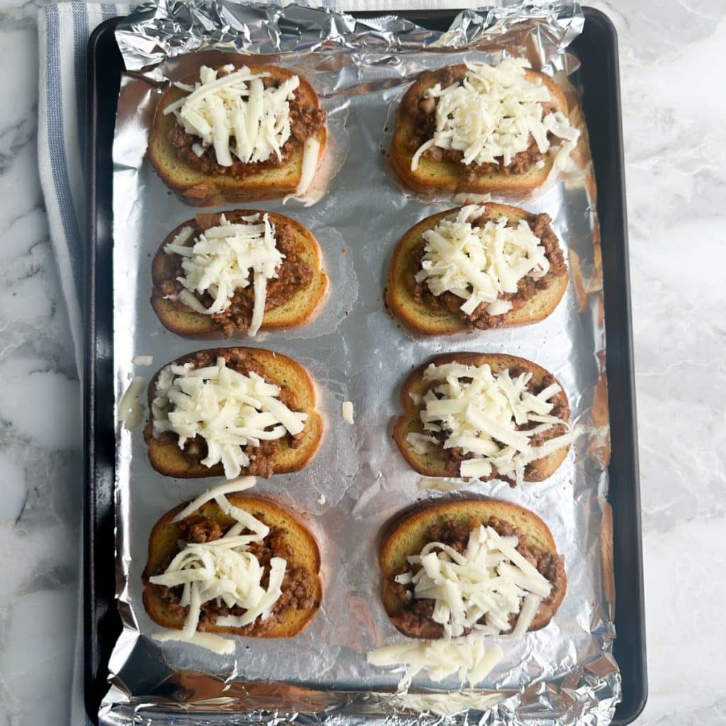 Pan with toast, meat, and cheese.