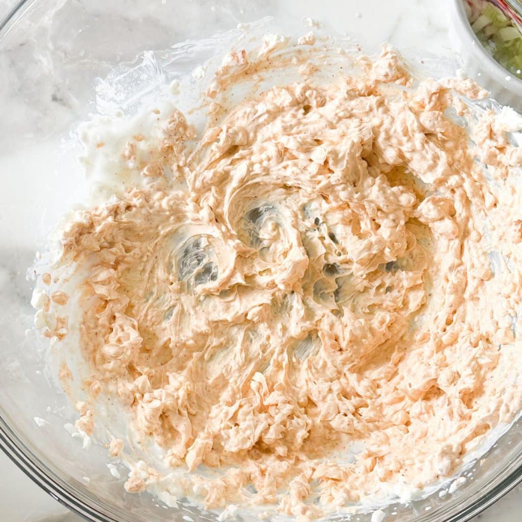 Bowl of whipped cream cheese and seasonings. 