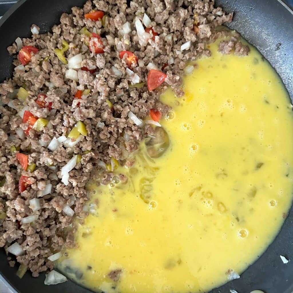 Sausage and egg in a skillet.