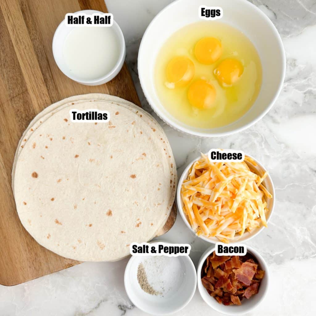 Bowl of eggs, cheese, bacon, and tortillas. 