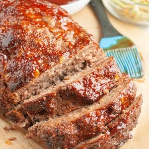 Sliced meatloaf and brush with bbq sauce.