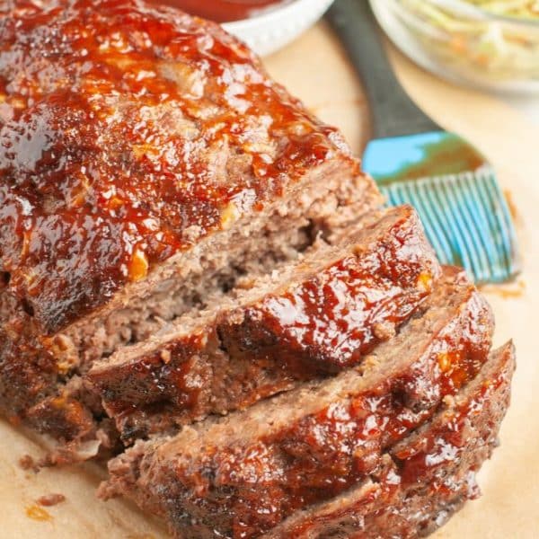 Sliced meatloaf with BBQ sauce.