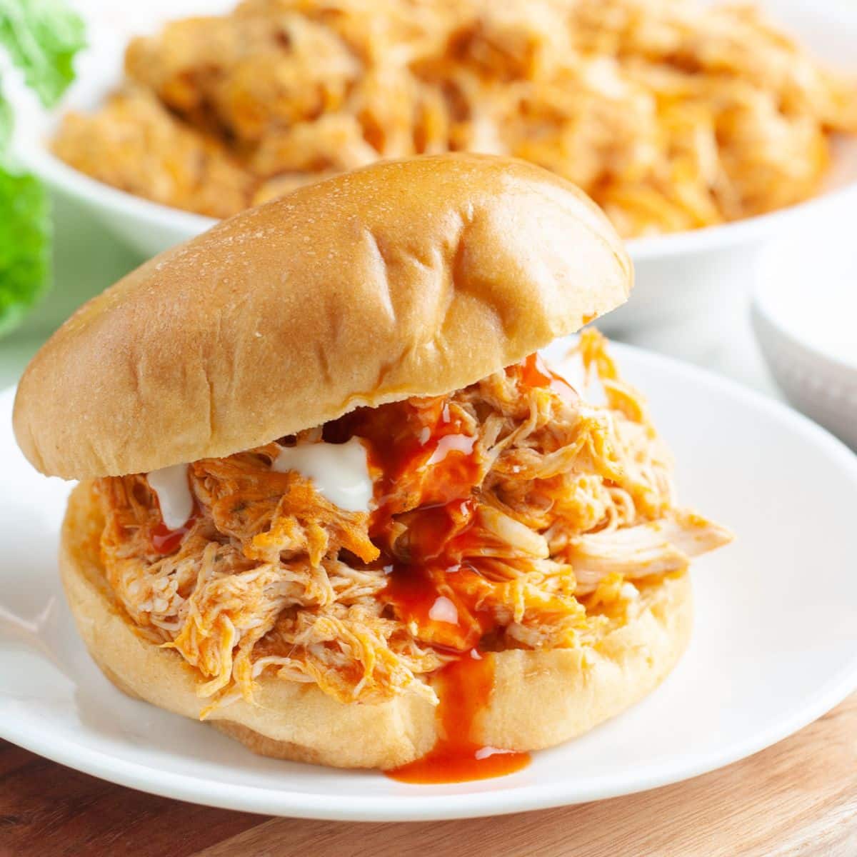 Shredded chicken sandwich with buffalo sauce.