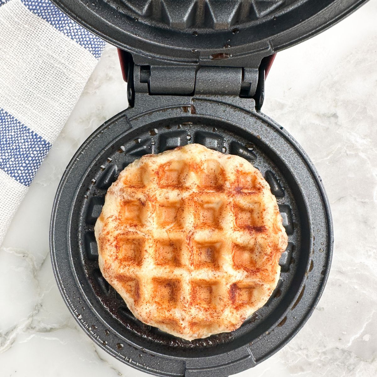 Cinnamon roll in waffle iron. 