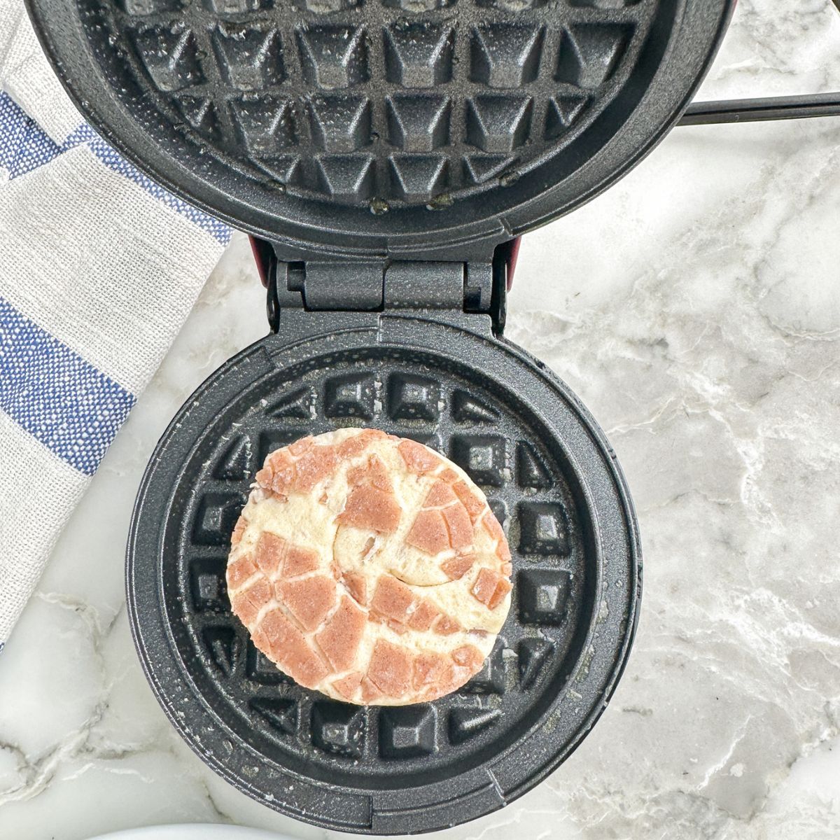 Cinnamon roll in a waffle maker. 