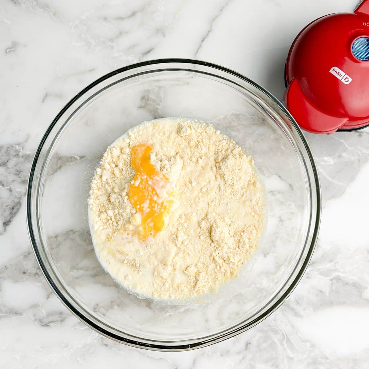 Bowl of cornbread, egg, and melted.