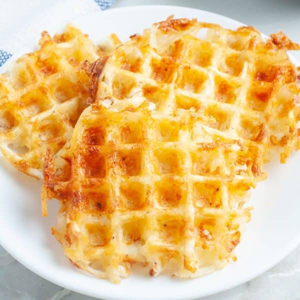 Three hash brown waffles on a plate.
