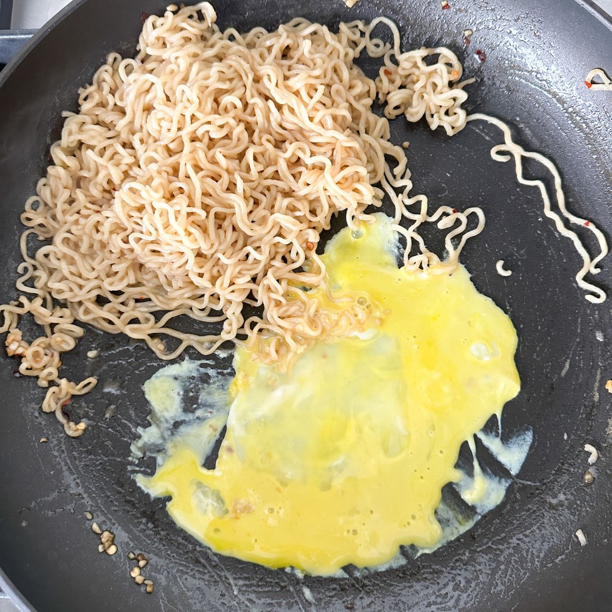 Noodles with egg in a skillet. 