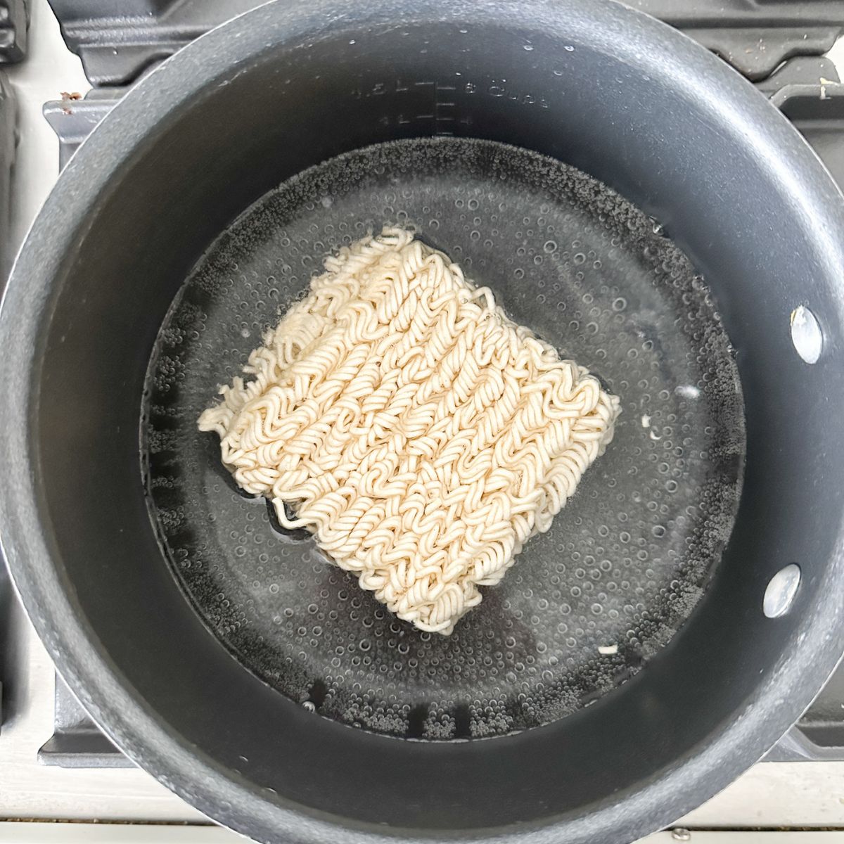 Ramen noodles in a pot of boiling water.