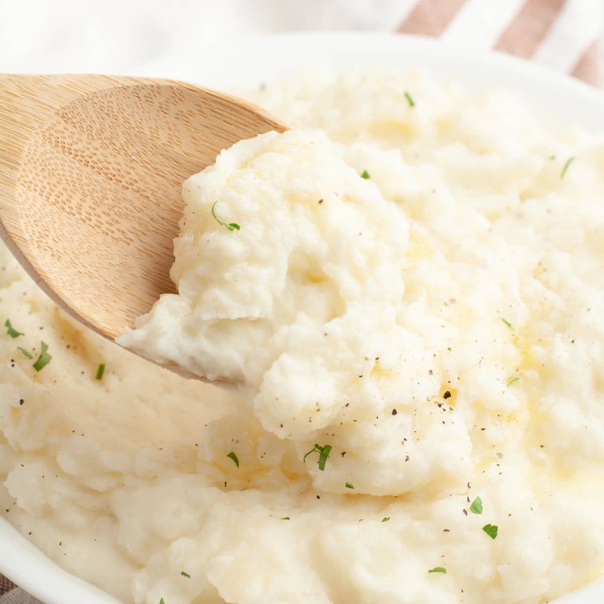 Wooden spoon with mashed potatoes.