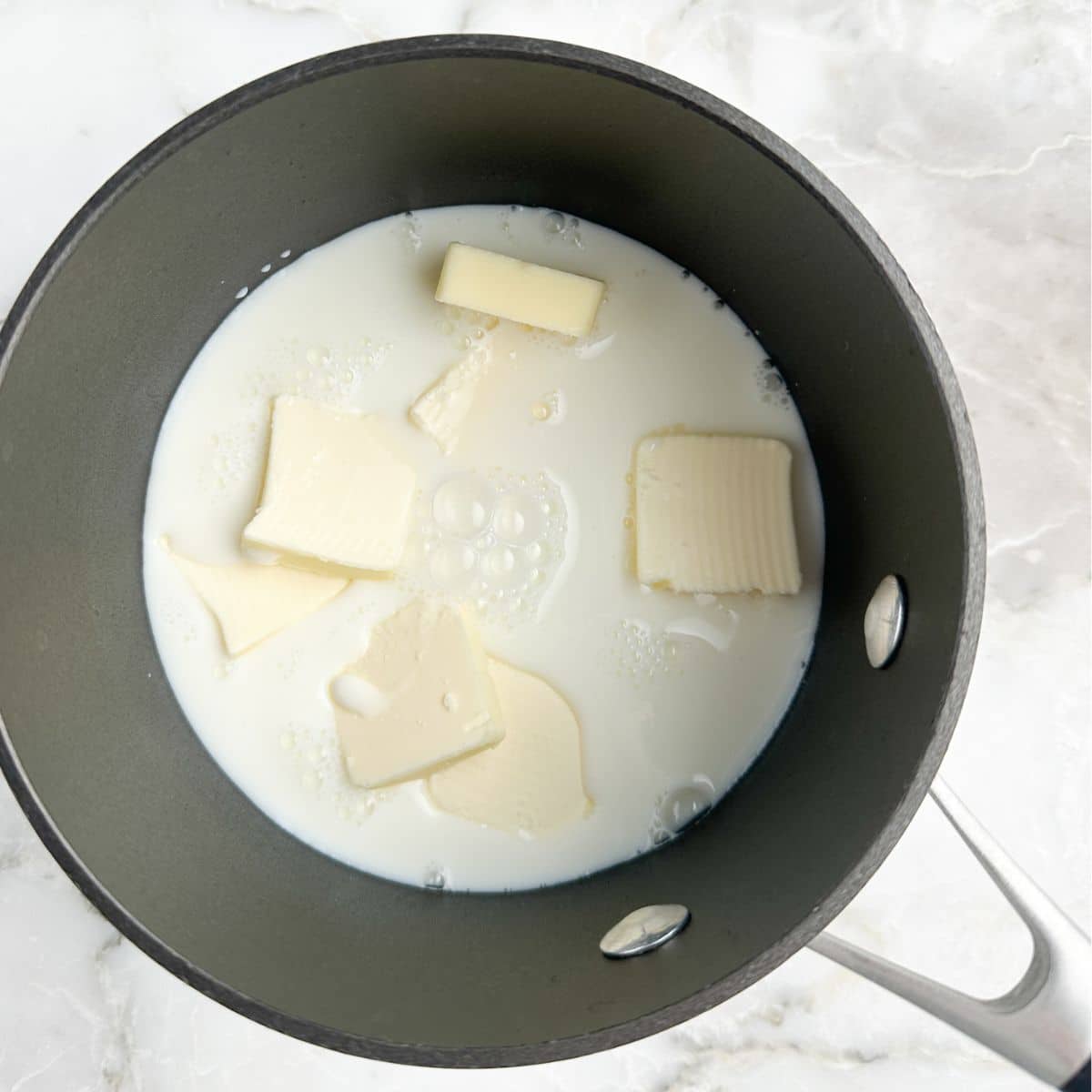 Saucepan with butter and milk. 