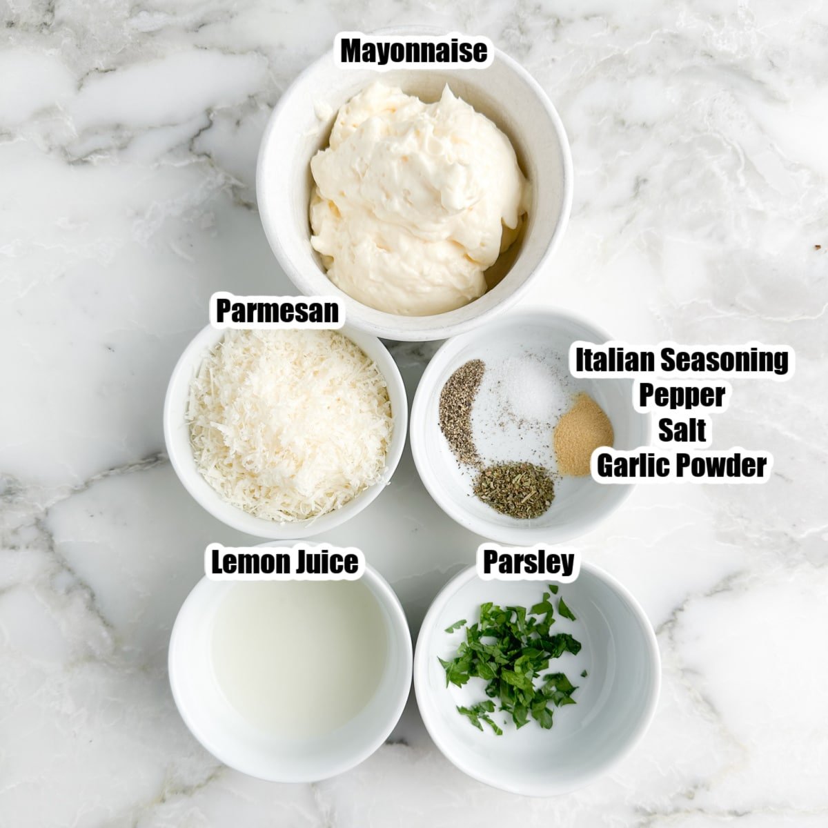 Bowl of mayonnaise, Parmesan cheese, seasonings, lemon juice, and parsley.