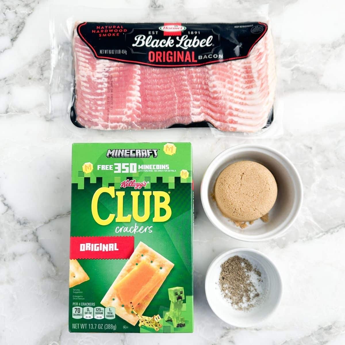 Box of club crackers, pack of bacon, bowl of brown sugar and pepper.
