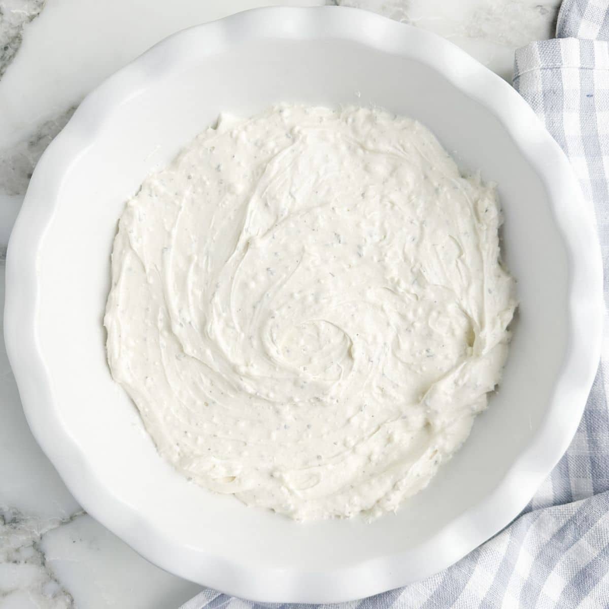 Pie plate with cream cheese spread. 