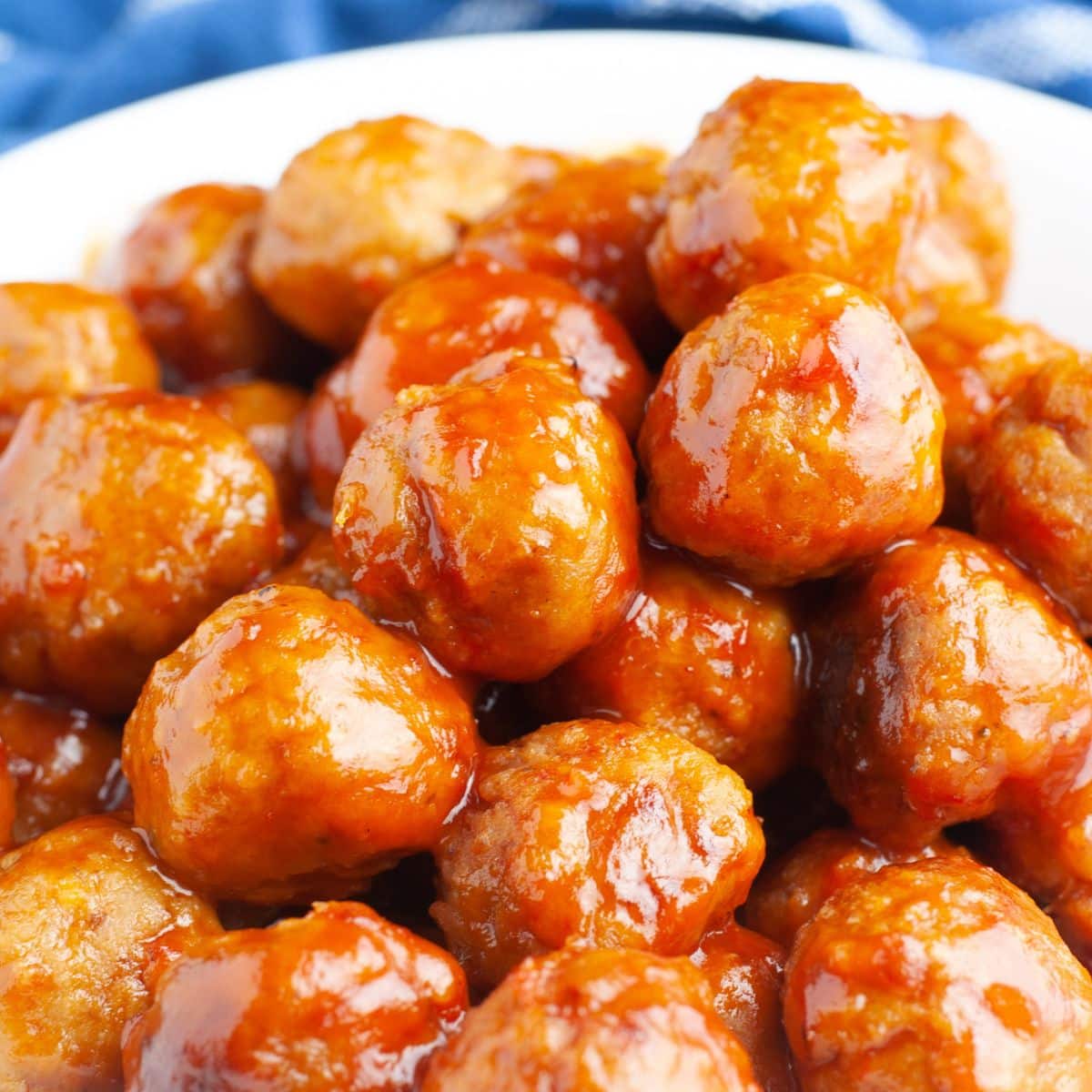 Bowl of meatballs covered in sauce. 